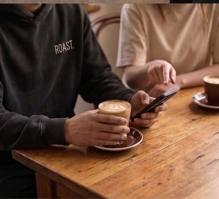 ROAST sleeve detail with coffee and phone